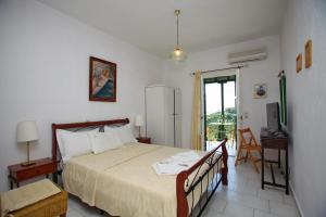 a bedroom with a bed and a door to a balcony at Pelagos in Stafylos