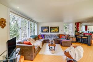 a living room with a couch and a tv at Contemporary Elka Park Retreat with Views and Deck! in Elka Park