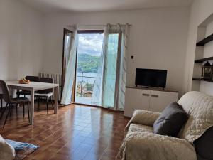 a living room with a couch and a table at CASA DEL SOLE in Tremezzo