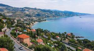 an aerial view of a town and a body of water at MeiMà Apartment Hanbury’s Gardens in Mortola Inferiore