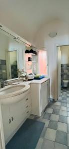 a bathroom with two sinks and a large mirror at MeiMà Apartment Hanbury’s Gardens in Mortola Inferiore