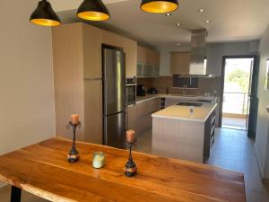 a kitchen with a wooden table with candles on it at Villa Melydron in Nafplio +50 photos