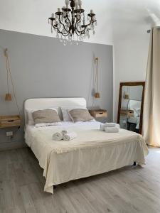 a bedroom with a large bed with towels on it at Sicilianamente Stay in Catania