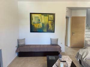 a living room with a couch and a painting on the wall at Villa Melydron in Nafplio