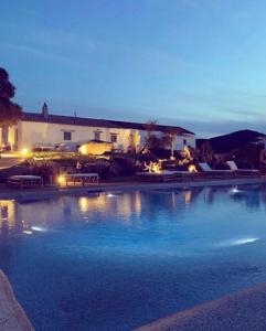 a large swimming pool in front of a building at Massidda Country Retreat in Santa Teresa Gallura