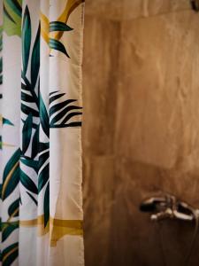 a shower curtain in a bathroom with a sink at Sunlight apartment in Nea Peramos +11 photos