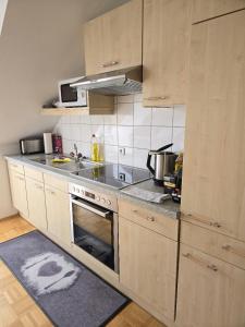 a kitchen with a sink and a stove top oven at Apartment inmitten der Stadt Leoben. in Leoben