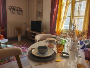 a living room with a table with a bowl on it at T2 54m² parking Cœur de Chartres in Chartres