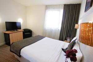 TV a/nebo společenská místnost v ubytování Golden Pebble Hotel
