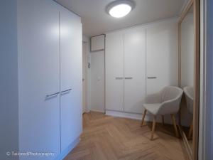 a room with white cabinets and a chair in it at Studiohuoneisto Ainonkatu AC, WiFi, balcony in Lappeenranta