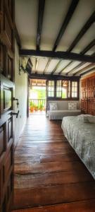 a large room with two beds and a wooden floor at Casa del Lavadero in Santillana del Mar