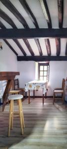 a room with a table and chairs and a window at Casa del Lavadero in Santillana del Mar