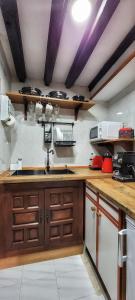 a kitchen with a sink and a counter top at Casa del Lavadero in Santillana del Mar