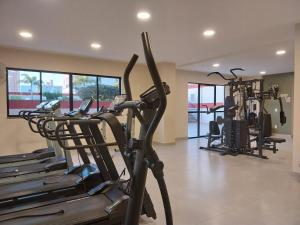 a gym with several treadmills and elliptical machines at Flat e Suíte no Via Park - NF e Wi-FI in Campos dos Goytacazes