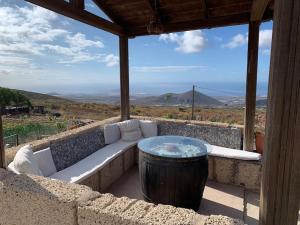 a patio with a bench and a table and a view at Casa Rural Tamaide in San Miguel de Abona