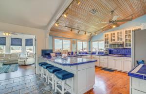 a kitchen with a large island with blue counter tops at Hernando Beach Home on Dolphin Cove Dock and Kayaks in Hernando Beach