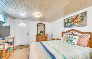 a bedroom with a bed and a mirror and a tv at Hernando Beach Home on Dolphin Cove Dock and Kayaks in Hernando Beach