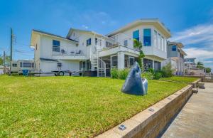 a large white house with a large yard at Hernando Beach Home on Dolphin Cove Dock and Kayaks in Hernando Beach