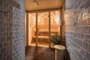 a bathroom with a sauna with a toilet and a tub at Oporto Maison Anselmo in Porto