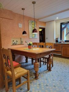 a dining room with a wooden table and chairs at Des 16ten Jahrhunderts Sonne in Schwanau +5 photos