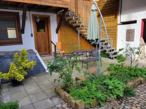 a patio with an umbrella and a bench and stairs at Des 16ten Jahrhunderts Sonne in Schwanau