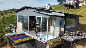 a tiny house with a pool on a hill at Barichara Glamping Valley in Barichara