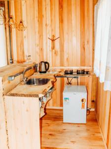 a kitchen with a sink and a stove at Sítio caminho das nascentes in Urubici +22 photos