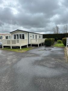 a mobile home parked in a parking lot at Secluded spot on Southview 8 berth in Lincolnshire