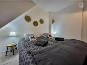 a bedroom with a large bed with pillows on it at Le brise lame maison neuve à 2 pas de la plage in Le Portel