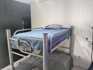 a bunk bed with a blue blanket on top of it at Casa Villas del Manantial in Durango