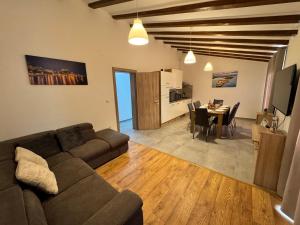 a living room with a couch and a dining room at Apartman Mediteran in Šibenik