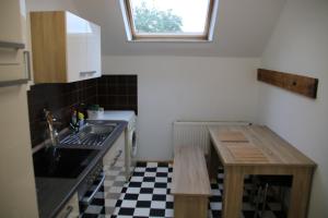 a small kitchen with a sink and a table at Dimis-Apartment in Cologne