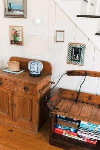 a room with a table with a lamp on top of a wooden cabinet at Maison Marigold ST-2019-0060-R5 in Bloomfield