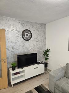 a living room with a flat screen tv on a wall at Apartment Mia in Mostar