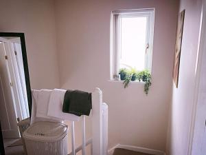 a white bathroom with a towel rack and a window at The Serene Stays - 3 Bed Home in Oldham Manchester in Oldham +47 photos