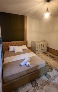 a bedroom with a bed with a towel on it at Pogradeci Lake Guest House in Pogradec +16 photos