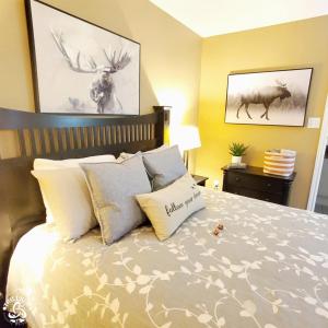 um quarto com uma cama com almofadas e pinturas de veados em Hillside Studio 2 in Blue Mountain, Unlimited Wifi & Free Parking em Blue Mountains