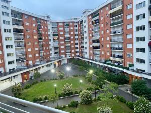 an apartment complex with a courtyard in front of tall buildings at Unik's Studio Apartment in Prizren