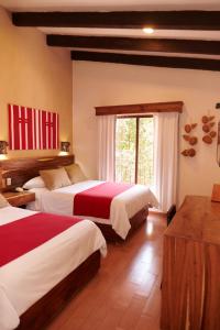 Un ou plusieurs lits dans un hébergement de l'établissement Hotel Mansion Del Valle