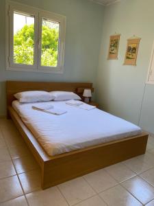 a large bed in a bedroom with a window at Thalassa Hideaway in Dhiminión
