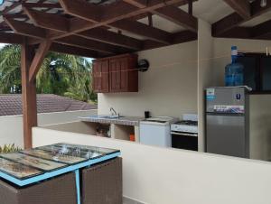 a kitchen with a stove and a counter top at Okaina Studio Rooftop in Cabarete