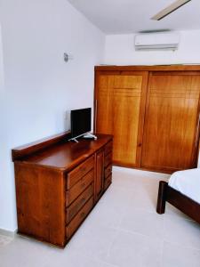 a bedroom with a wooden desk with a computer on it at Okaina Studio Rooftop in Cabarete