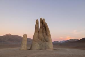 a sand sculpture of a hand in the desert at Holiday Inn Express - Antofagasta by IHG in Antofagasta