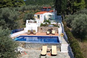 a house with a swimming pool next to a house at Pelagos in Stafylos