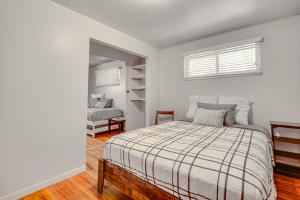 a white bedroom with a bed and a window at Salt Lake City Home Close to Trails and Museums! in Salt Lake City