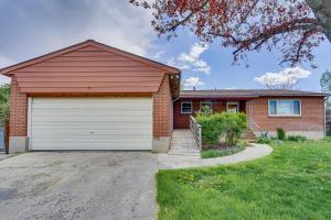 a red brick house with a white garage at Salt Lake City Home Close to Trails and Museums! in Salt Lake City