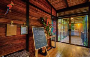 a room with a chalkboard on a wooden wall at La Shamana - Ecological Concept in Jungle in Cahuita