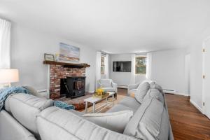 a living room with a couch and a fireplace at 21 Dexter Avenue Sandwich - Creekhaven Cottage in Sandwich
