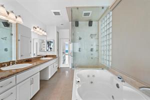 a white bathroom with two sinks and a tub at 3 Story Oceanfront Home with Jacuzzi in Newport Beach on the Sand! in Newport Beach