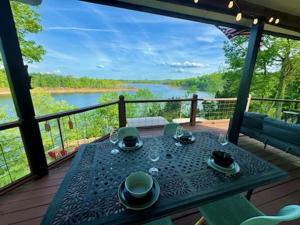 a table on a deck with a view of a river at 530 Fentress Lookout Rd in Fentress McMahan